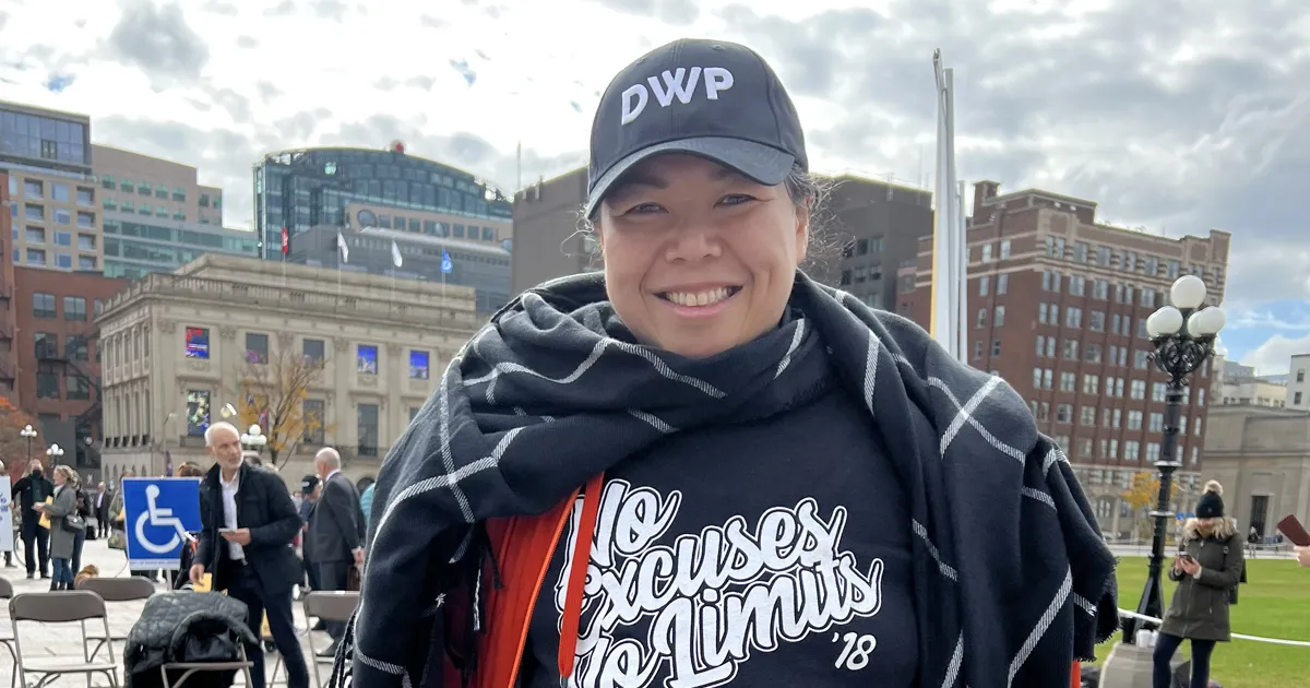 Clare Li with No Excuses No Limits tshirt and DWP baseball cap