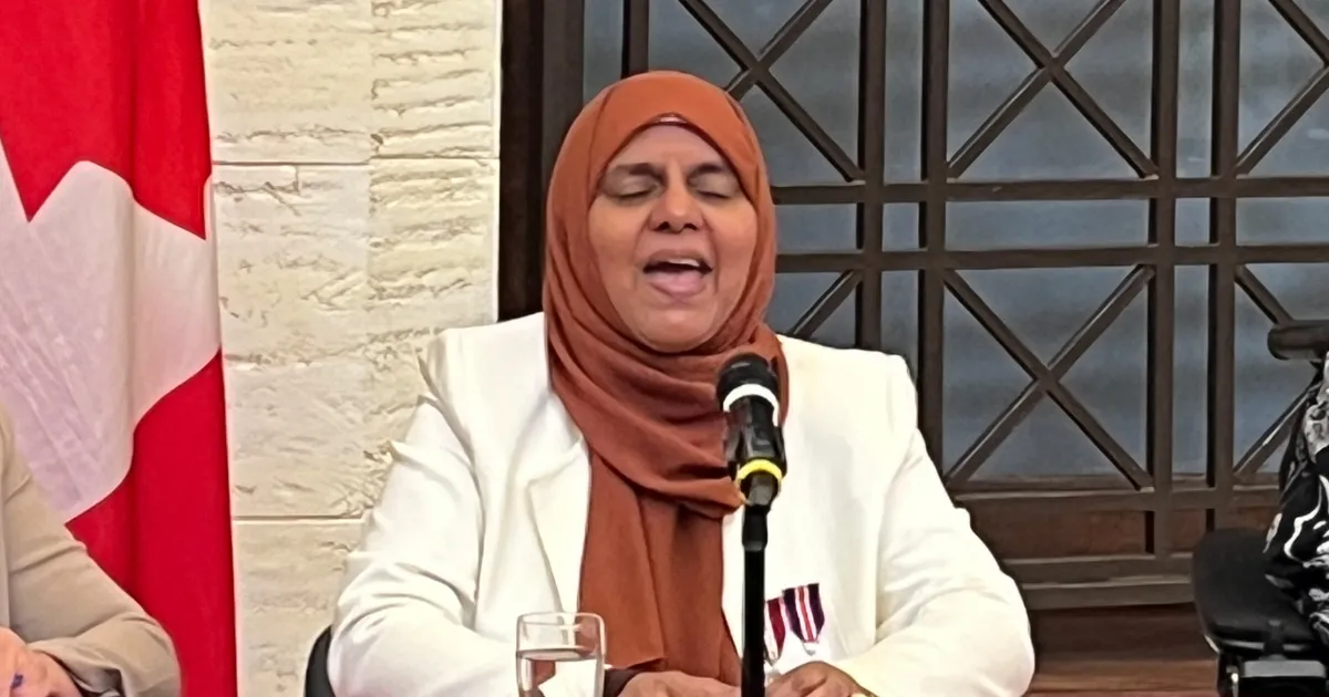 Rabia Khedr with brown headscarf and white blazer